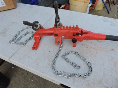 Place the strap around the workpiece. . Chain vise soil pipe wrench whandle